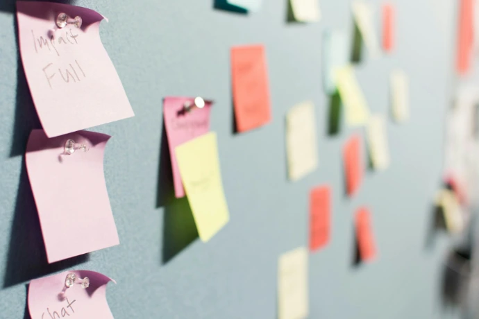 colorful sticky notes pinned to board